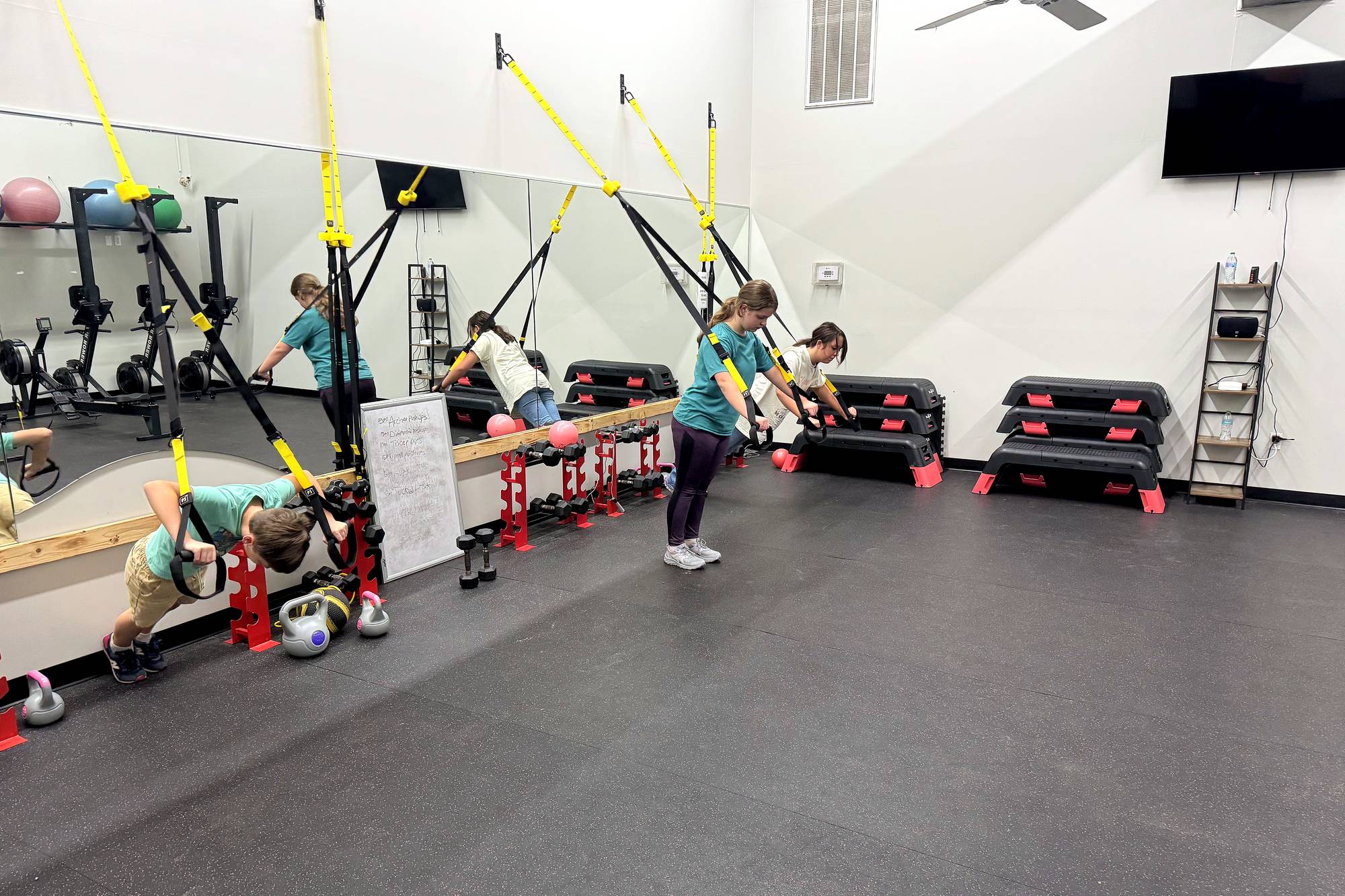 Circuit room with TRX suspension straps, step platforms and kettlebells